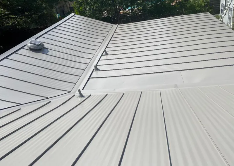 Solar attic fan installed on a metal roof for Roof Ventilation in Ironton